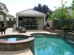 pool and spa with outdoor kitchen and living suite