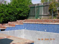 pool with brick retaining wall