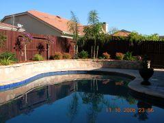 pool with stone faced retaining wall