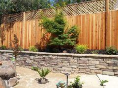 fence and stone faced retaining wall
